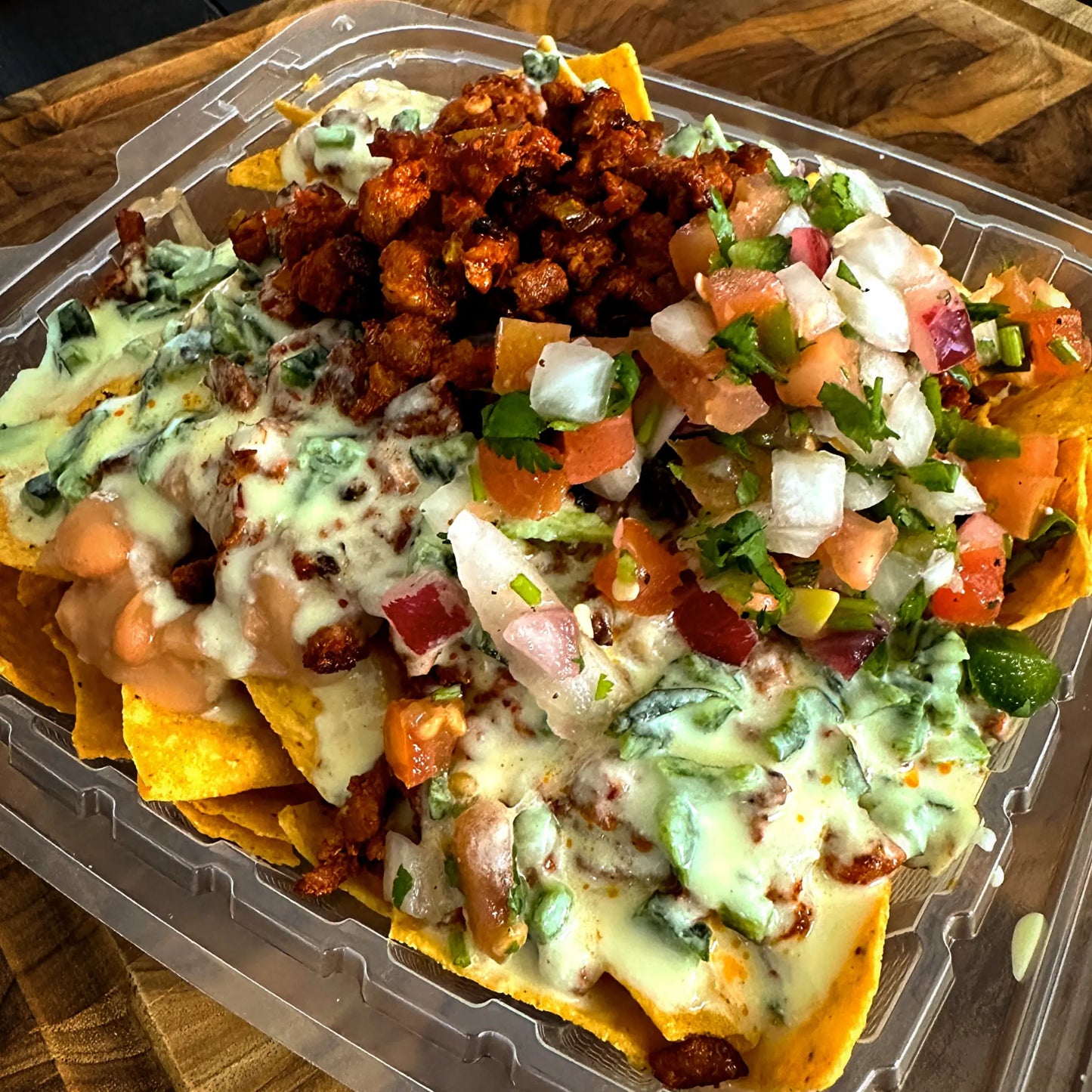 Carnivore Nachos topped with choice of meat, beans, pico de gallo, and house-made queso blanco on crispy tortilla chips.