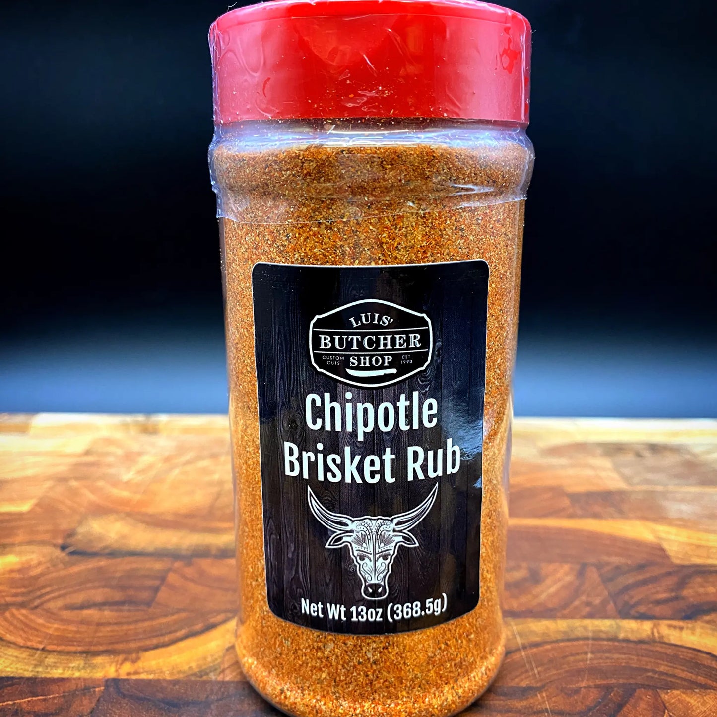 A jar of Luis' Butcher Shop Chipotle Brisket Rub, ideal for adding a smoky kick to beef and pork.