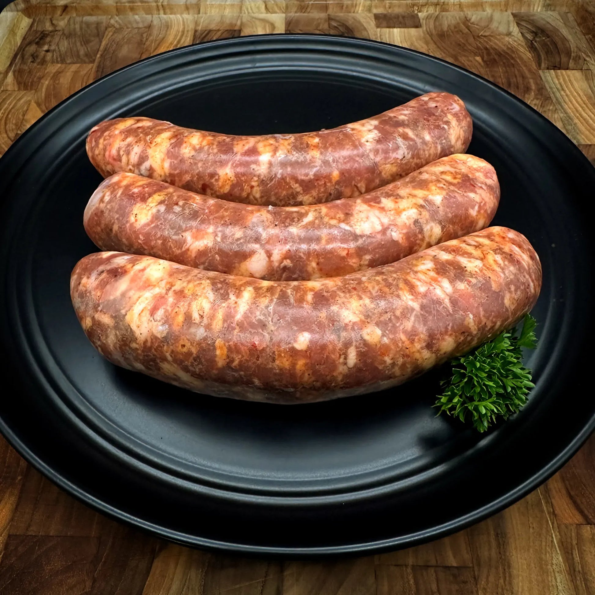 Image of Argentine Sausage (Chorizo Argentino), showcasing pork sausages seasoned with white wine, beer, and authentic Argentine spices.