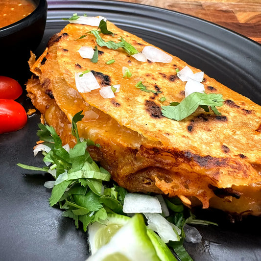 Hickory-smoked brisket tucked in a cheddar quesadilla taco shell, finished with onion and cilantro. New at Luis' Butcher Shop.