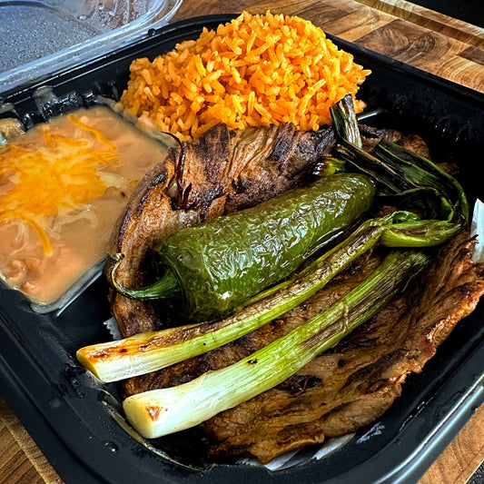 Carne Asada Plate with USDA Prime sirloin flap, rice, beans, tortillas, fried jalapeño, grilled onions, and fresh pico de gallo.