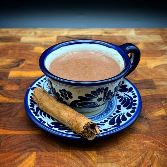 A cup of Champurrado, a traditional Mexican drink made with corn starch, Mexican chocolate, sugar, and cinnamon.