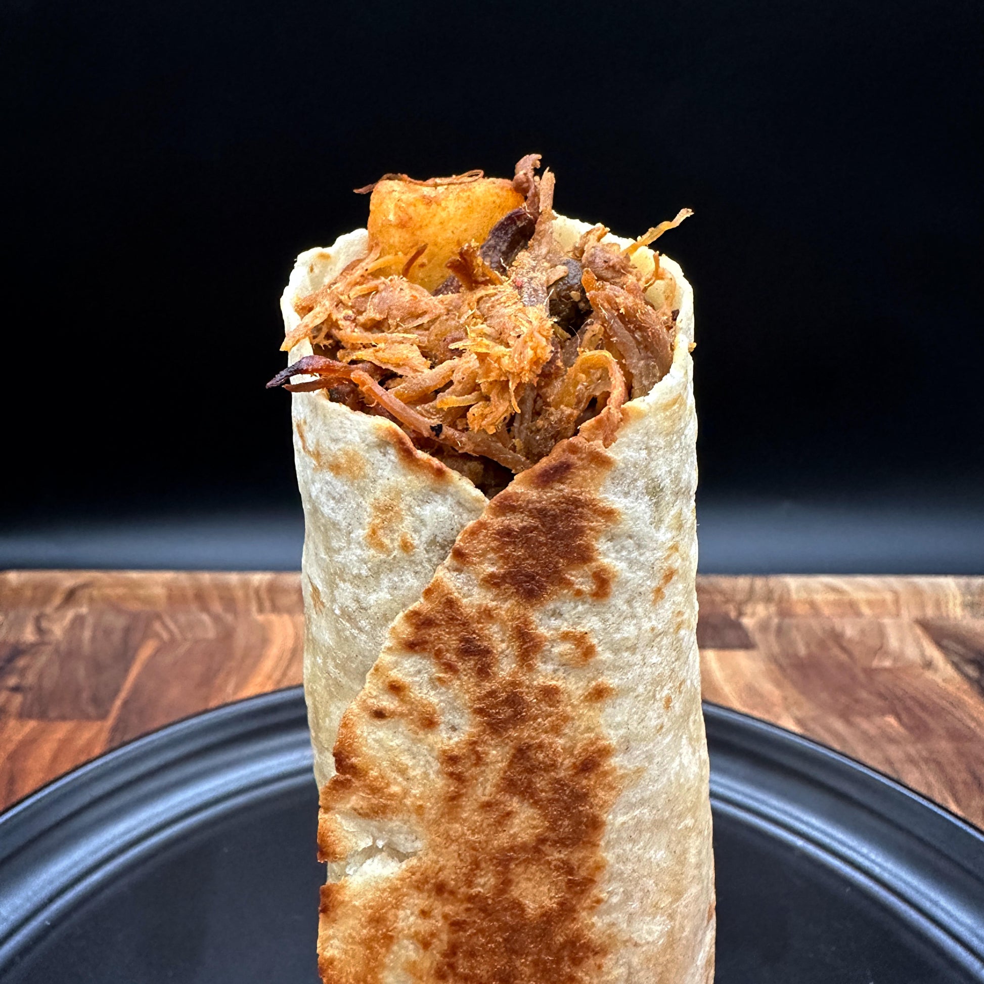 Express breakfast burrito with seasoned shredded pork, ground beef, egg and potatoes wrapped in a flour tortilla