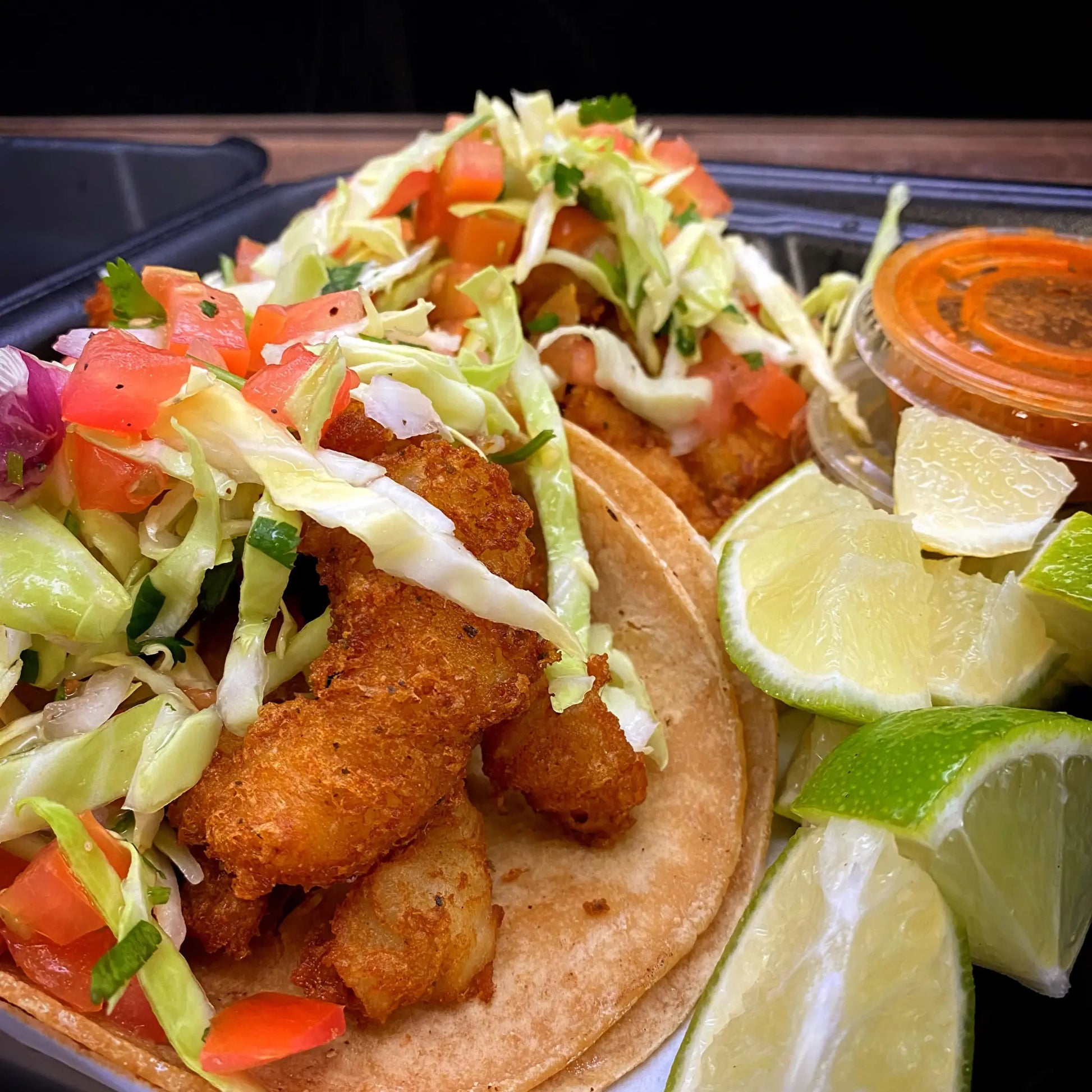 Fish Taco with battered and fried Swahi filet, cabbage, and pico de gallo in a soft tortilla.
