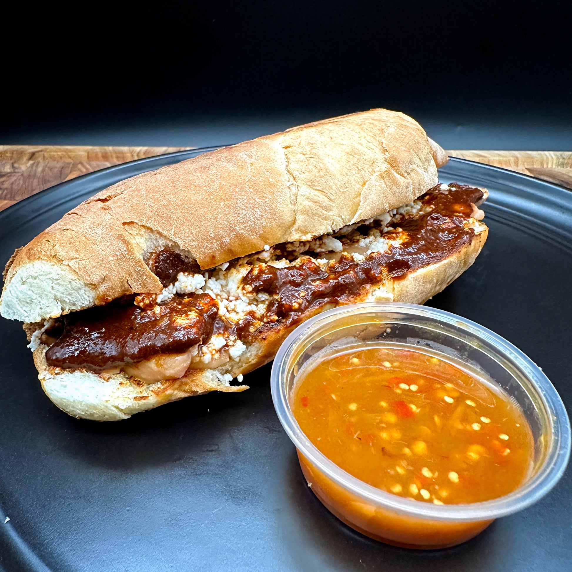 Poblano sencillo no meat sandwich with mole poblano, queso fresco and beans on bolillo roll with seasoned fries