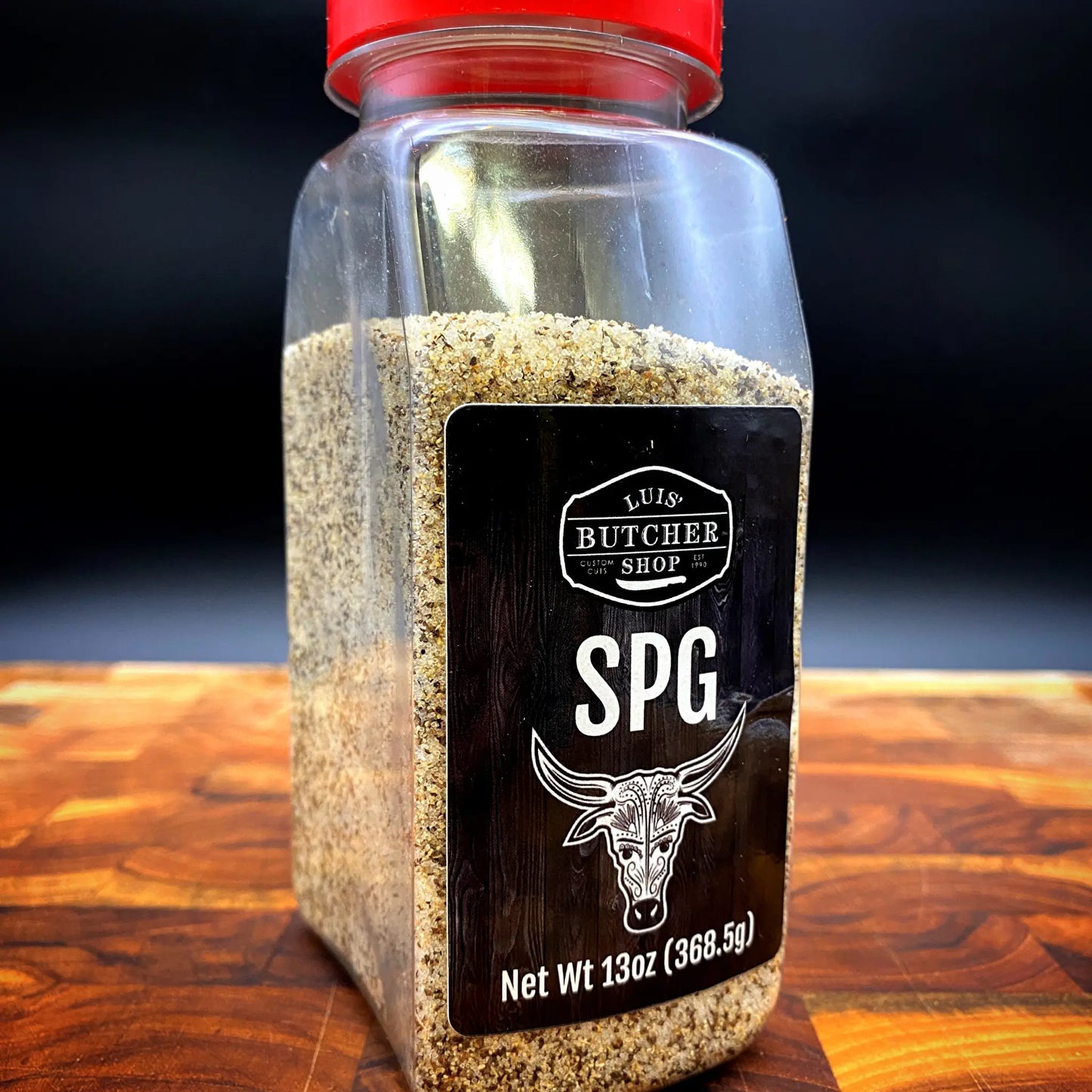 A jar of Luis' Butcher Shop SPG Seasoning, a flavorful blend of salt, pepper, and garlic, perfect for brisket and rib roast.