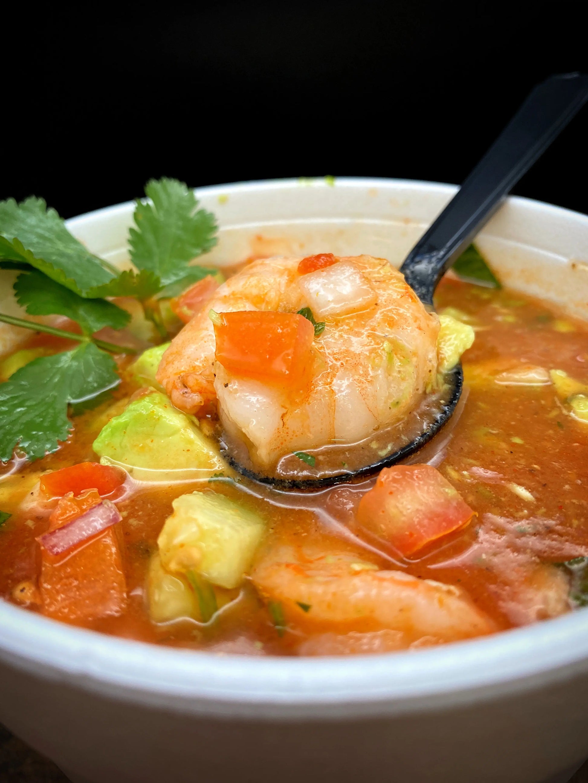Shrimp Cocktail with tomato juice, cucumber, cilantro, tomato, avocado, and tortilla chips.