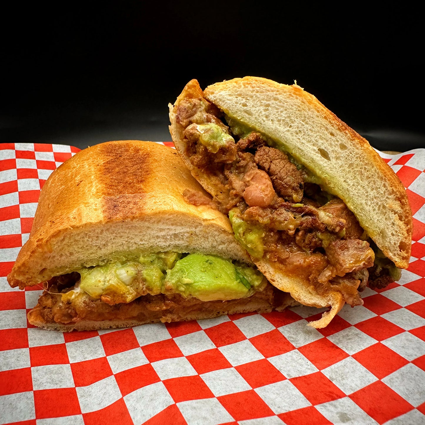 Torta with meat, cheese, sour cream, guacamole, and beans.