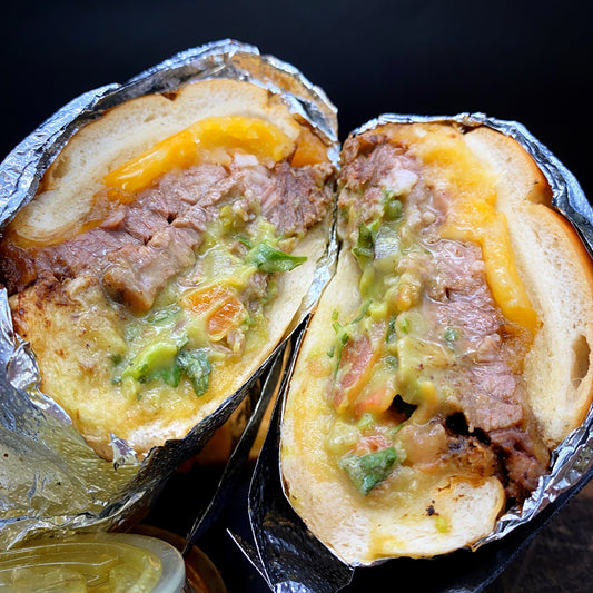 Brisket Sandwich with hickory smoked brisket, guacamole, and cheese.