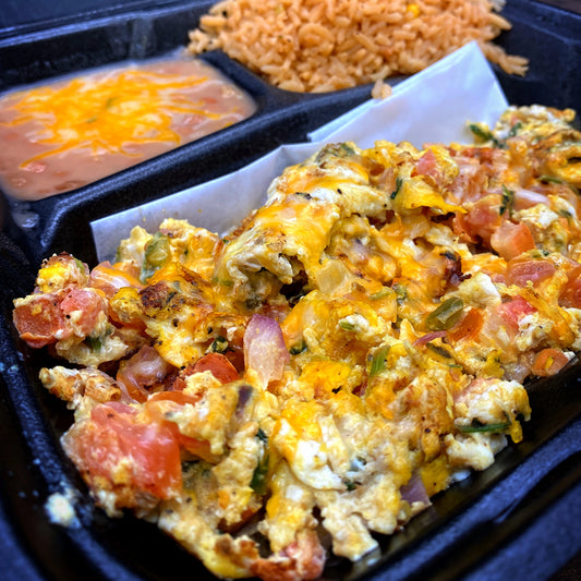 Huevos A La Mexicana with tortillas, rice, and beans.